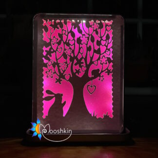 Lantin featuring a rabbit gazing up at a heart-filled tree, backlit with white LEDs