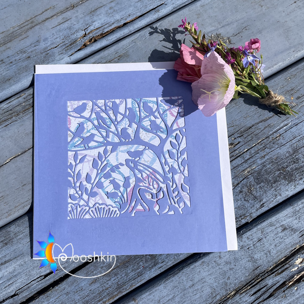 Handmade die cut greetings card featuring birds, a tree, and a hare