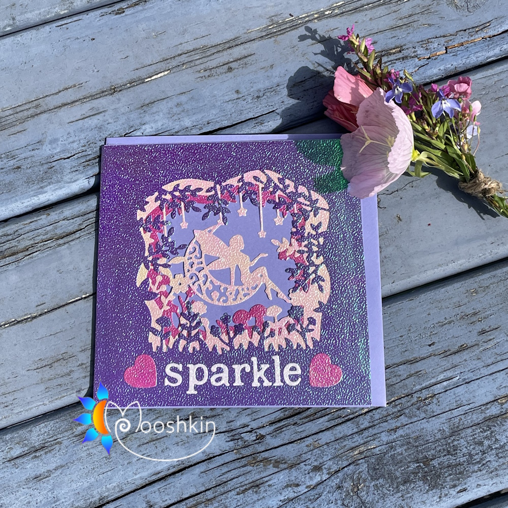 Iridescent 3-layered die cut handmade greetings card featuring a fairy sitting on a crescent moon and surrounded by stars and flowers