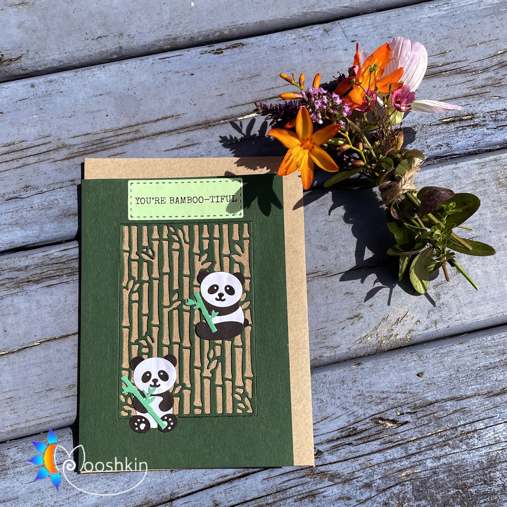 Handmade die cut greetings card featuring two pandas overlaid on a bamboo forest, with the greeting "you're bamboo-tiful" at the top