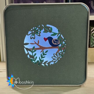 "Springtime is here" - a multi-coloured, multi-layered Lantin by Mooshkin - a light-up die-cut scene in a tin