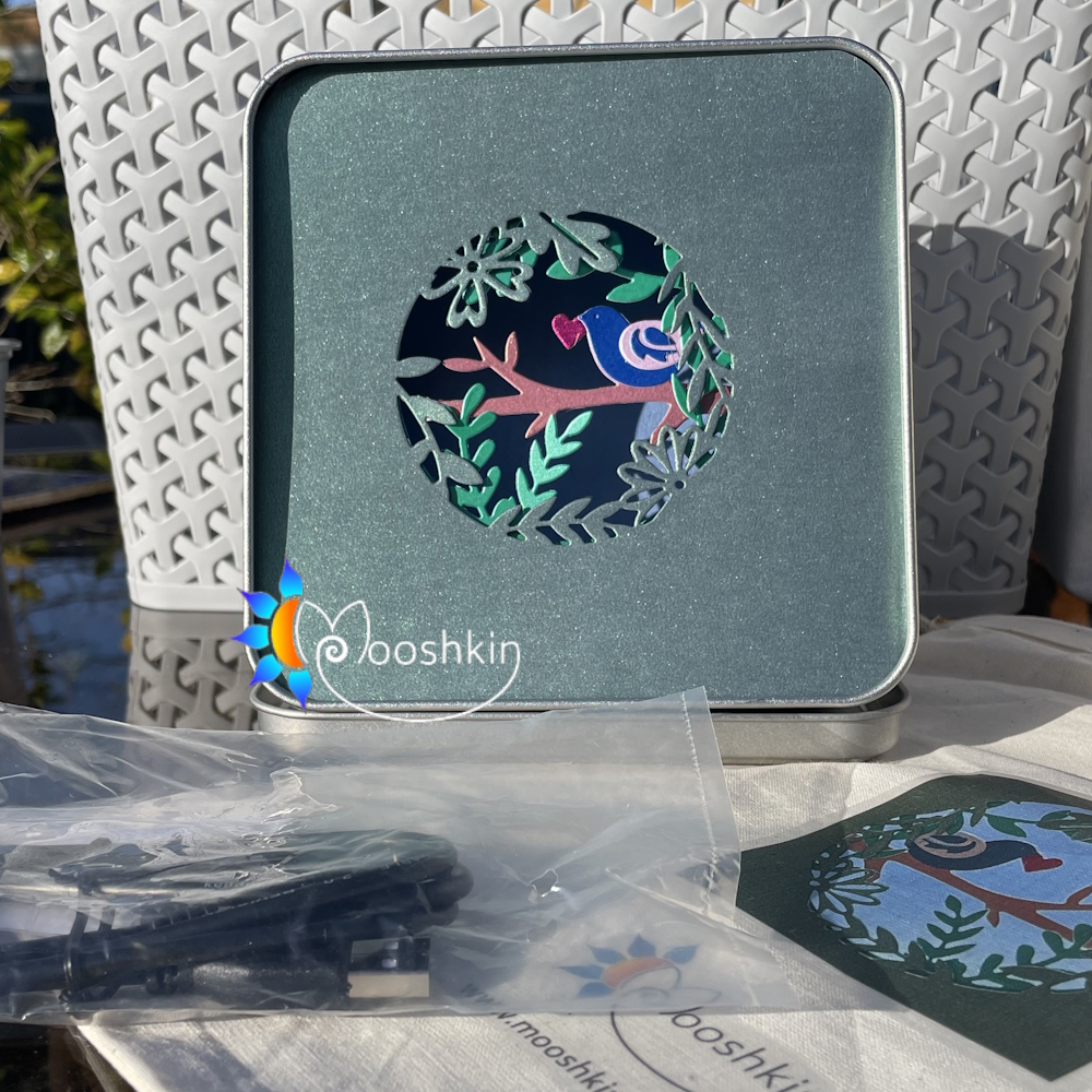 "Springtime is here" - a multi-coloured, multi-layered Lantin by Mooshkin - a light-up die-cut scene in a tin