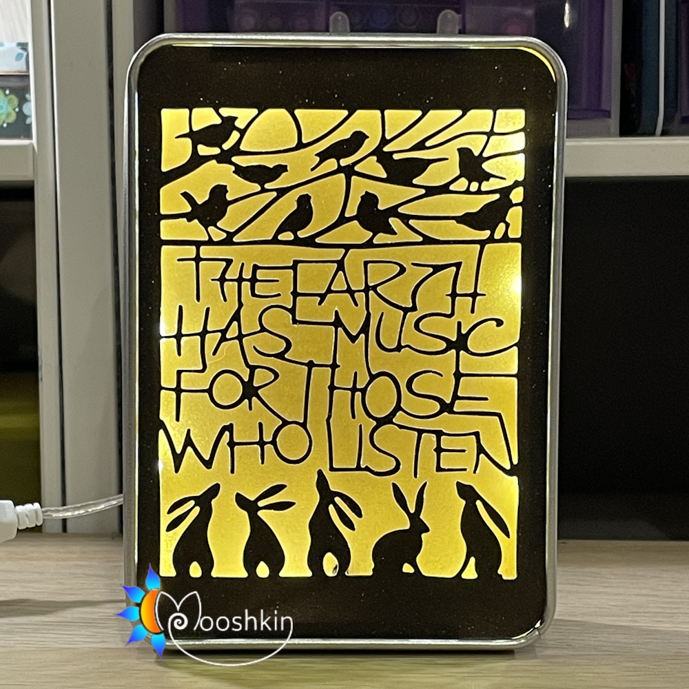 A die-cut message says "the earth has music for those who listen", in a light-up tin