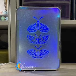 Lantin by Mooshkin: a trio of die-cut butterflies appears to prepare to fly away from this light-up tin