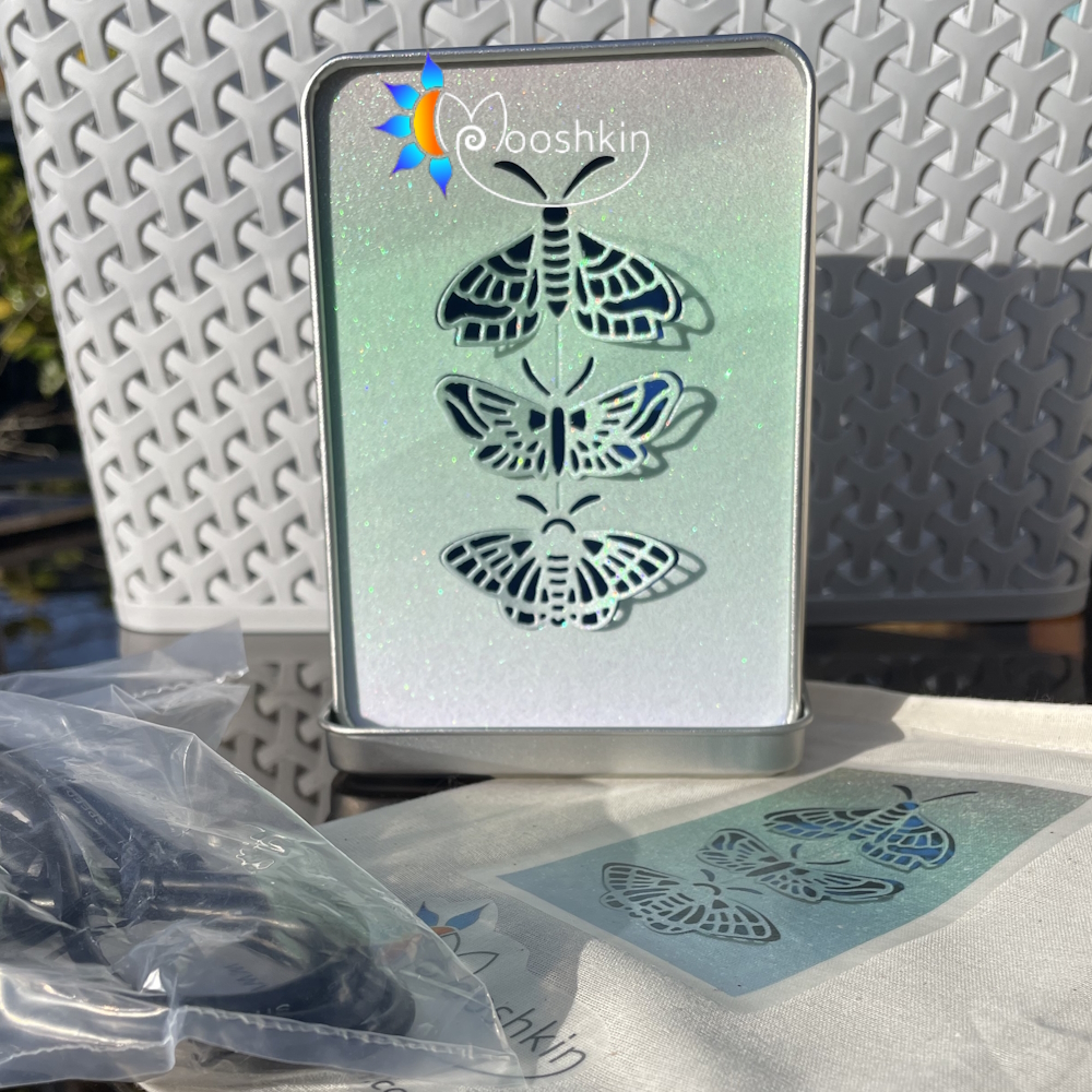 Lantin by Mooshkin: a trio of die-cut butterflies appears to prepare to fly away from this light-up tin