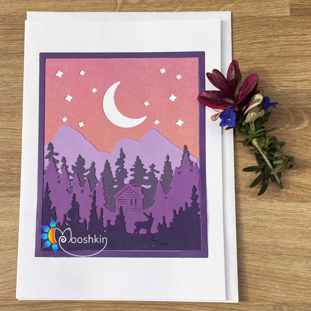 Handmade die cut greetings card featuring multiple die-cut layers in different coloured card, which together form a mountain/forest scene