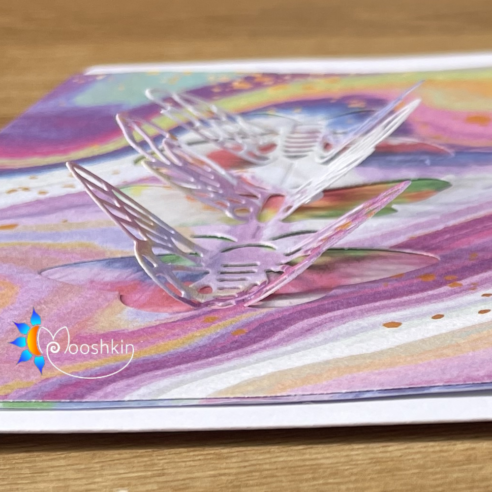 Handmade greetings card, blank for your own message. Three die-cut butterflies on very colourful cardstock.