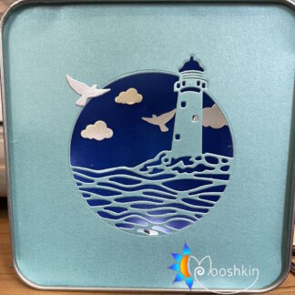 Mooshkin Lantin - light-up scenes in tins - featuring a lighthouse and waves with clouds and birds.