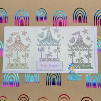 Handmade die cut greethings card featuring glittery carousels for a new baby