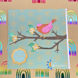 Handmade die cut greetings card featuring a pink and orange bird sitting on a blossom-filled branch.