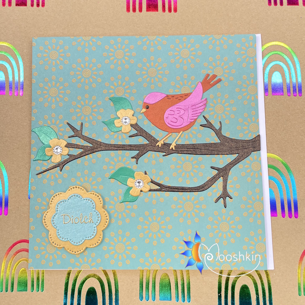 Handmade die cut greetings card featuring a pink and orange bird sitting on a blossom-filled branch.