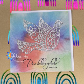 Handmade die cut birthday card featuring a silver glitter dove on a rainbow tie dye background