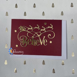 Handmade Christmas card: die cut of the word 'believe' with Santa flying his sleigh above