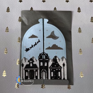 A handmade Christmas card featuring a die cut village scene on a jar-shaped card