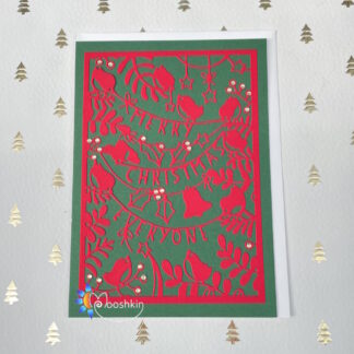Handmade Christmas card: the message 'merry Christmas everyone' die cut into green card, on a red background, with birds, bells and wintry foliage
