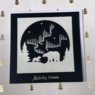 A handmade Christmas tree featuring the northern lights sparkling above a polar bear and her cub