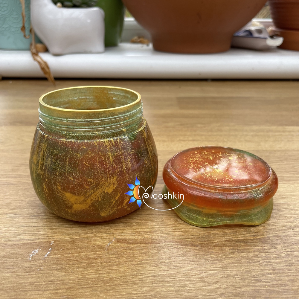 Handmade resin screw-top jar in red, gold and green