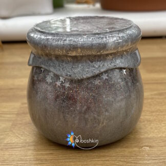 Handmade resin screw-top jar in silver with red glitter and silver stars
