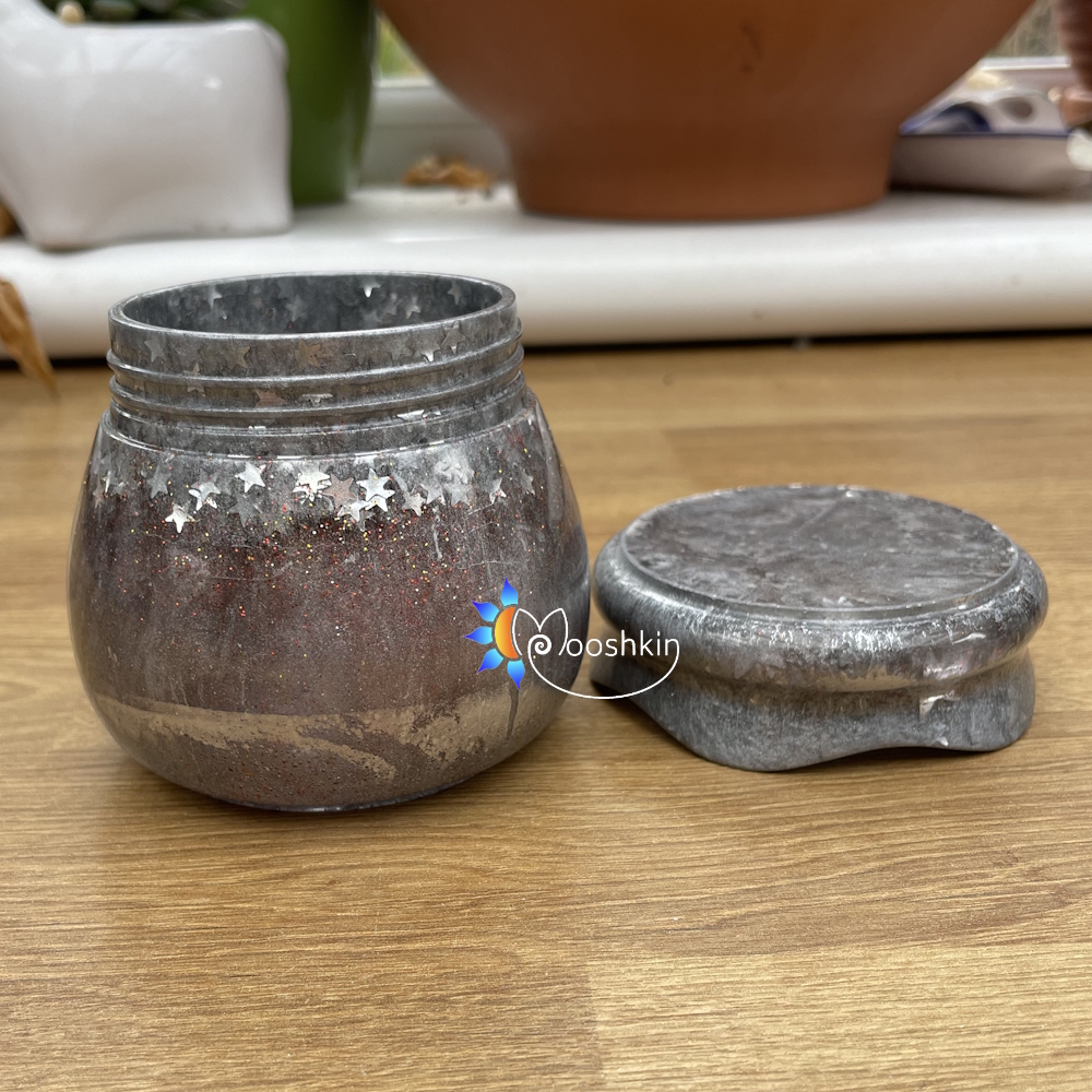Handmade resin screw-top jar in silver with red glitter and silver stars