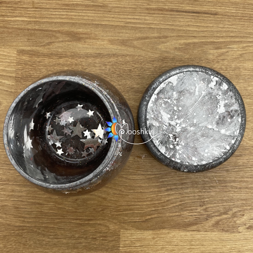 Handmade resin screw-top jar in silver with red glitter and silver stars